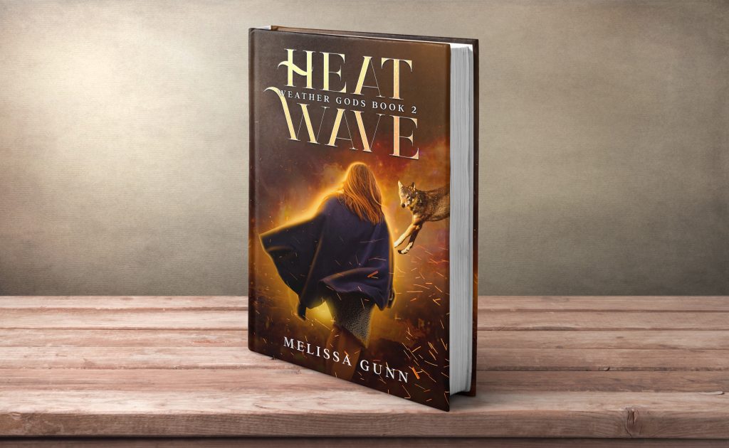 Picture of book Heat Wave by Melissa Gunn. Cover has a girls in a cloak and a wolf leaping towards her