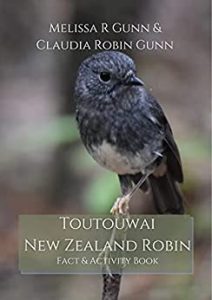 Picture of book showing NZ robin (grey and white bird) sitting on a twig.